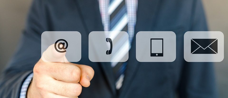 man pointing at sign phone mail and location icon e1554790100635 - Contact